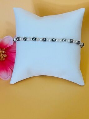 Rice pearl bracelet with gold & silver tone spacers plu a silver plated toggle